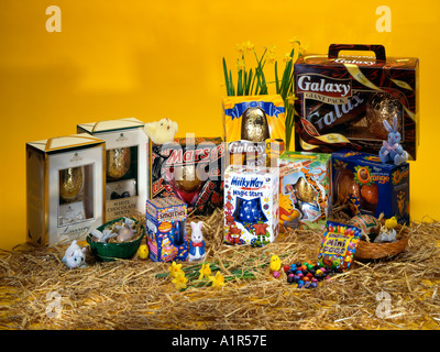 Selection of ten Easter Eggs on straw, with a yellow background. Stock Photo