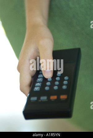 Hand pressing button on remote control Stock Photo
