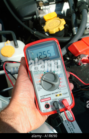 Digital Voltmeter Reading of 12 volt car battery Stock Photo