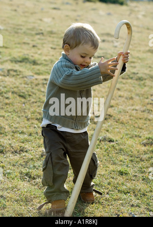 Boy holding cane Stock Photo