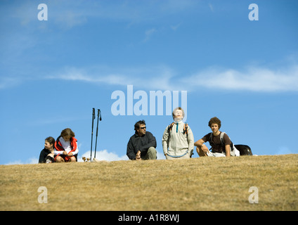 Hikers taking break, one with eyes closed and head back Stock Photo