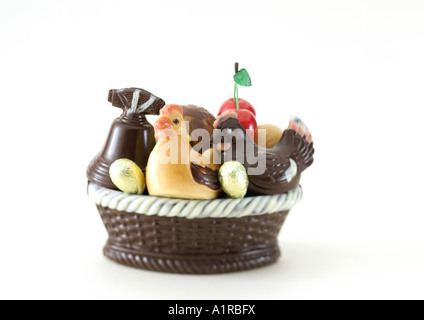 Basket of chocolate chickens, eggs and bell Stock Photo