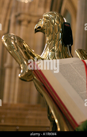Golden Lectern: A sculpture of a large brass bird holds a bible Stock Photo