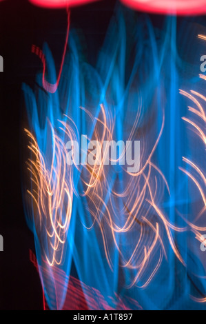 An abstract motion blurred image of a neon sign in blue and red and yellow Stock Photo