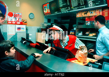 Paris France, young teenage french girl Working in Fast Food Restaurant, interior, Taking order From Boy  at Counter, teenagers jobs, teenager Stock Photo