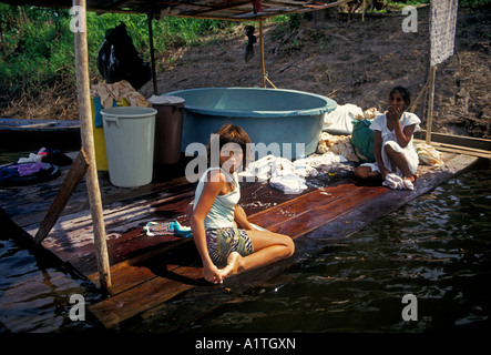 1, one, Brazilian girl young child washing clothes cleaning clothes in river, Rio Ariau, Ariau River, Amazonas State, Brazil, South America Stock Photo