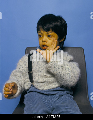 CHILD USING SIGN LANGUAGE TO COMMUNICATE Stock Photo