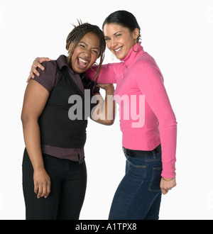 Portrait of two friends, African American and Caucasian silhouetted on white background Stock Photo