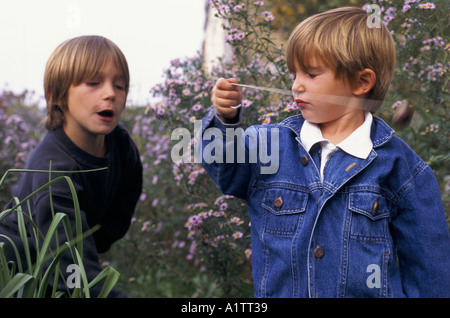 CHILDREN LOUIS 7 THEO 4 PLAYING CONKERS 10 1995 Stock Photo