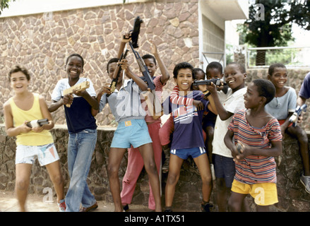 MOZAMBIQUE MAPUTO BOYS PLAYING WITH TOY GUNS Stock Photo