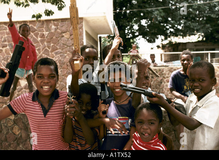 MOZAMBIQUE MAPUTO BOYS PLAYING WITH TOY GUNS Stock Photo