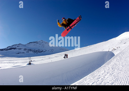 Snowboarder Thomas Wyden jumping on the glacier of  Laax Stock Photo