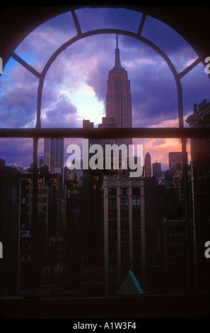 New York NY The Empire State Building framed through a Manhattan office window Stock Photo