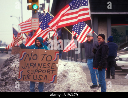 Center Line Michigan Auto workers picket a Toyota dealer waving American flags to protest Japanese imports Stock Photo