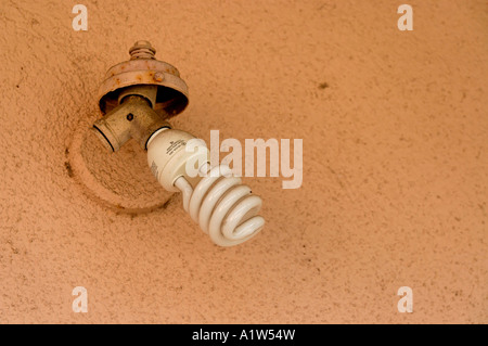 A modern compact fluorescent light bulb in an old fashioned exterior light fixture on a house in the suburbs of Los Angeles, California, USA Stock Photo