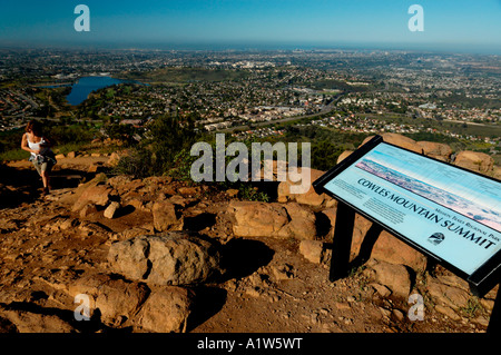 Female hiker arriving at top of Cowles Mountain in San Diego California Stock Photo