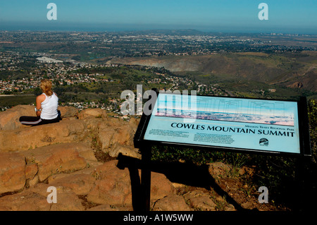 Woman takes in view from the summit of Cowles Mountain in San Diego California Stock Photo