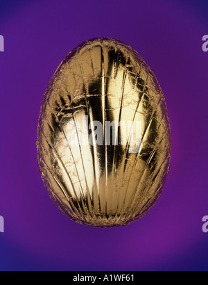 Chocolate Easter egg covered in gold foil Stock Photo