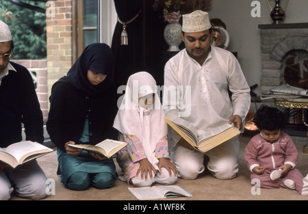 Muslim family praying in the home at end of Ramadam Stock Photo