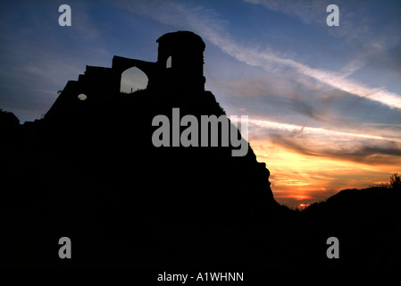 Sunset and silhouette of Mow Cop, a folly south of Congleton, Cheshire, UK Stock Photo