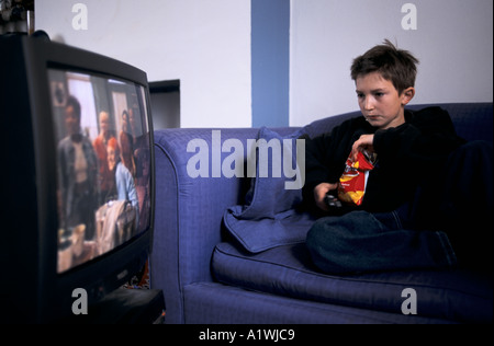 BOY WATCHING TV, sitting on settee 2001 Stock Photo