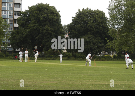 Men playing cricket London Fields Stock Photo