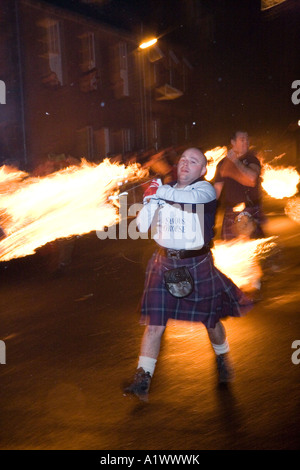 Stonehaven Fireball fire Ceremony in the High Street.  Hogmanay. New Year festival, a fiery party, men swinging fiercely flaming balls in Scotland, UK Stock Photo