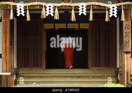 A priestess at Fushimi Inari Shrine in Kyoto Japan Stock Photo