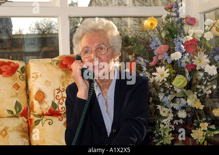 Elderly woman talking on the telephone Stock Photo