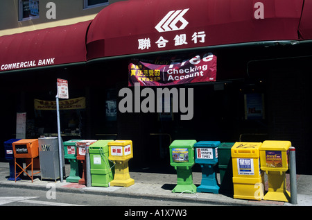 News stand vending machines outside bank with bilingual English and Chinese signs China Town San Francisco California USA Stock Photo