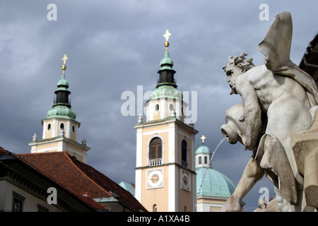 Robba Fountain of Carniolan Rivers and St Nicholas Cathedral in Ljubljana Slovenia Stock Photo