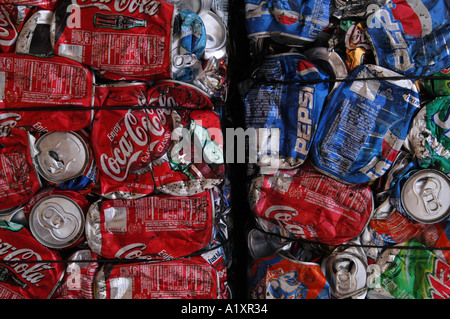 Crushed and compacted empty tin beverage cans Coca Cola Pepsi and other soft drinks squeeze compact squash squashed pressed Stock Photo
