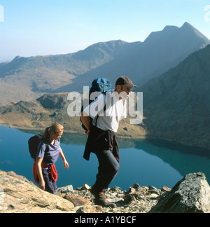 Couple hiking together walking up Mount Snowdon on the Pyg track in Snowdonia National Park Gwynedd North Wales UK KATHY DEWITT Stock Photo