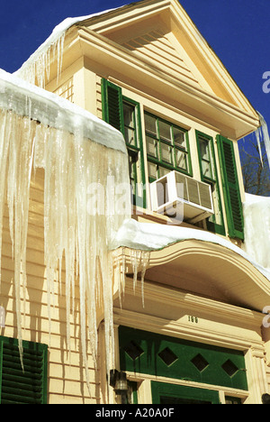 Yellow house with icecicles in winter Fredericton New Brunwick Canada Stock Photo