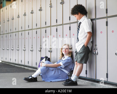 Two elementary school students waiting by school lockers Stock Photo