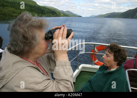 Women sitting on a day trip pleasure cruiser on Loch Ness hoping to see Nessie the Loch Ness Monster, Scotland Stock Photo