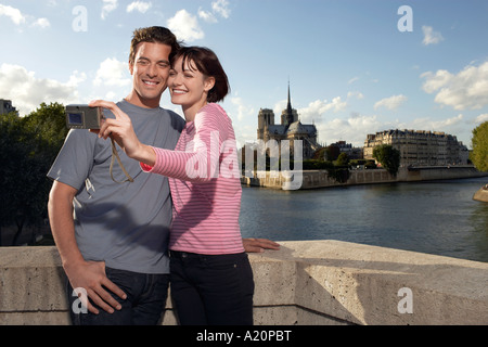 Paris, France, Couple taking a photo of themselves, in front of Notre Dame Cathedral Stock Photo