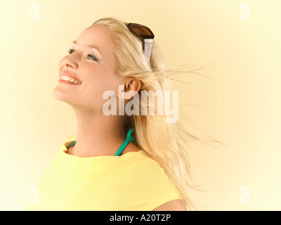 Smiling Woman, hair blowing, side view Stock Photo