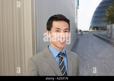 Young Businessman standing outside, smiling Stock Photo