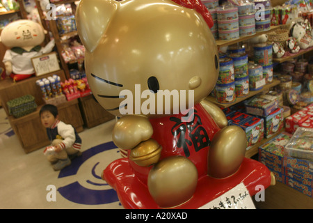 A Japanese child in a shop selling Hello Kitty character goods in the LaQua shopping arcade, Tokyo, Japan. Stock Photo