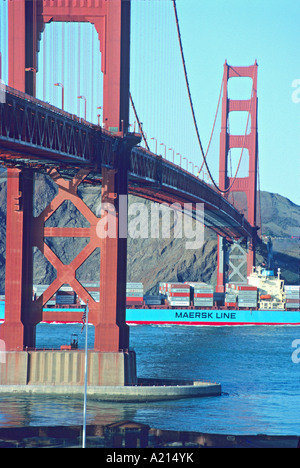 container ship passing under Golden Gate Bridge San Francisco California Stock Photo