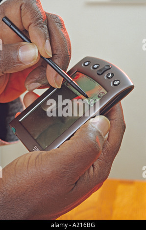African American man hands using Personal Digital Assistant PDA Stock Photo