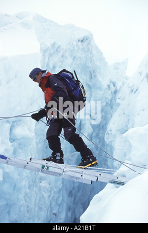 Crossing a crevasse on Mount Everest in the Khumbu Icefall Stock Photo ...