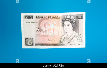 Old style British ten 10 pound bank notes on blue Stock Photo