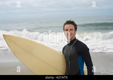 Man Holding Surfboard Stock Photo