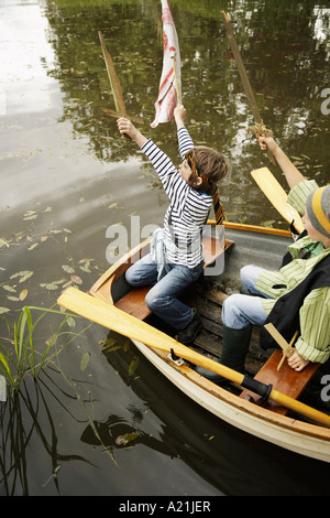 boys in rowboat pretending to be pirates stock photo - alamy