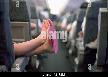 Girl's Feet in Airplane Stock Photo