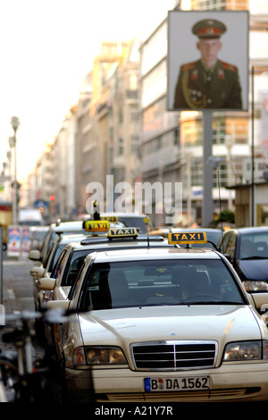 Taxis at checkpoint Charlie, the commemorative control point where the border used to be between East and West Berlin in Germany Stock Photo