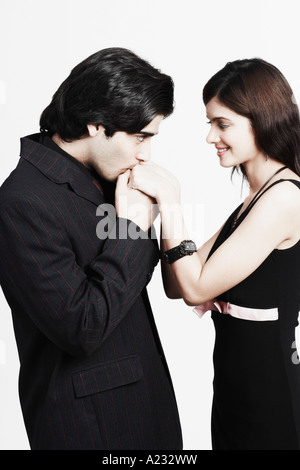 Profile of a man kissing a young woman's hand Stock Photo - Alamy