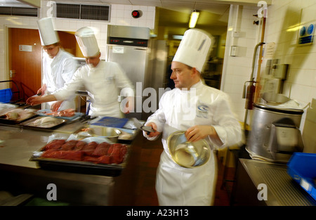 Chefs working hard in a hot kitchen Stock Photo